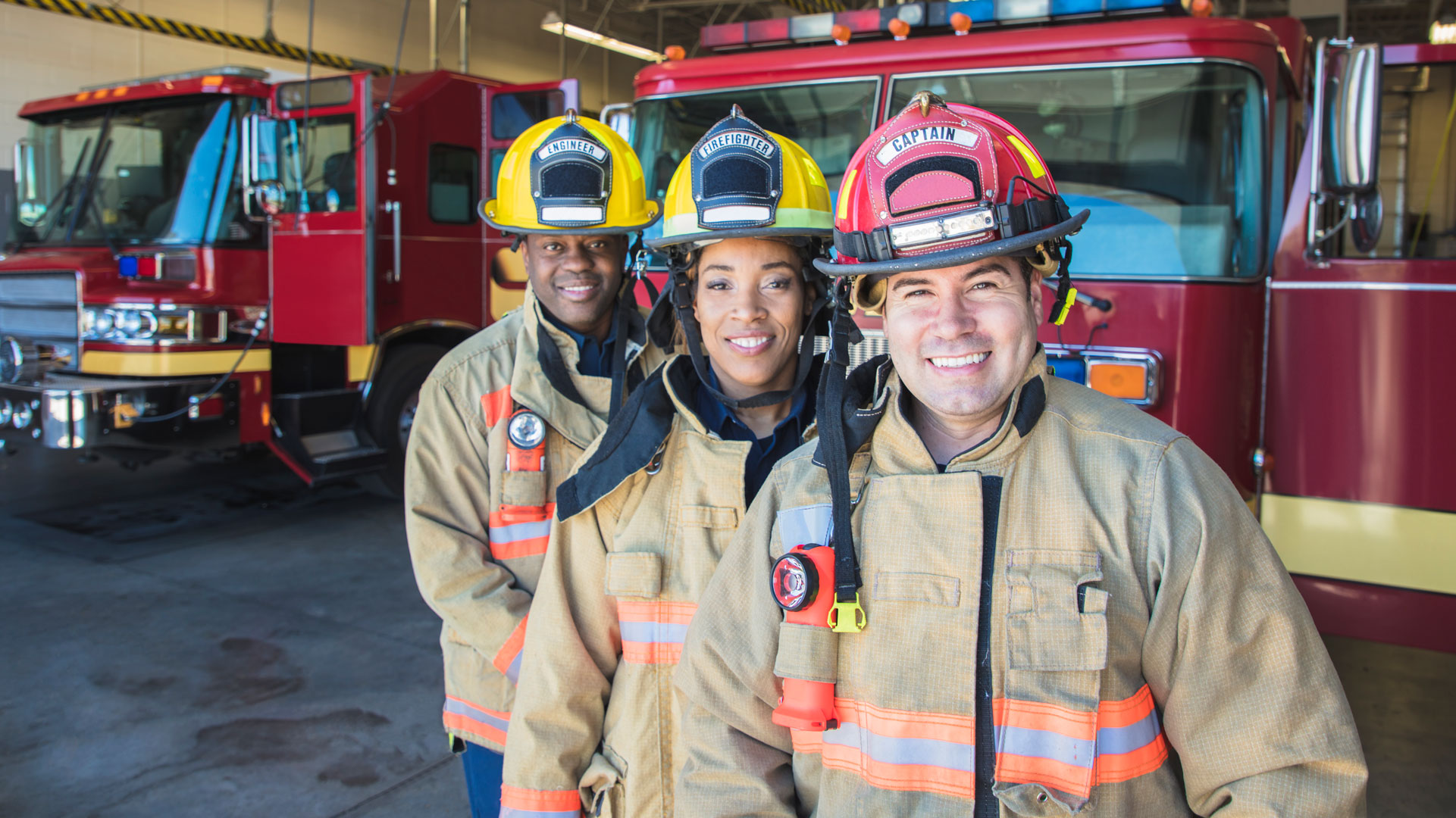 Three smiling fire fighters